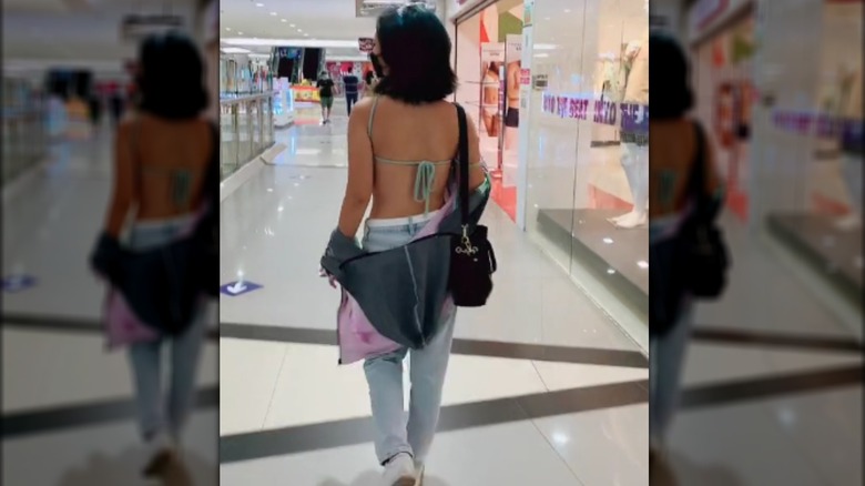 Woman in backless top walking