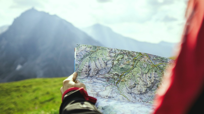 Mountain hiker examining map