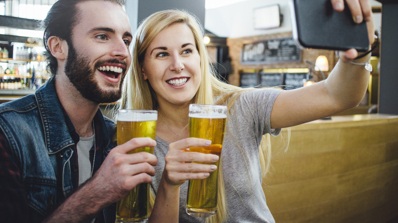 Travelers drinking at airport bar