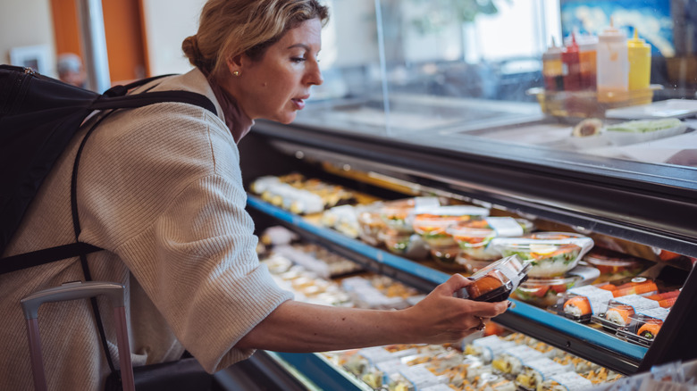 Traveler grabbing sushi box