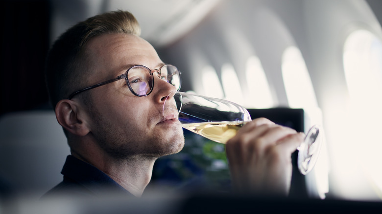 Airplane traveler sipping champagne