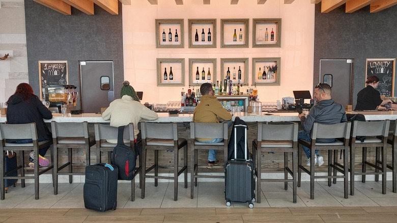 Travelers drinking at hotel bar