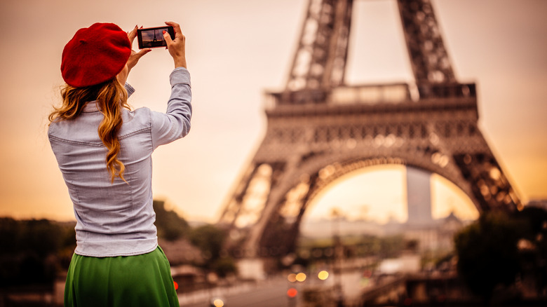 woman photographing Eiffel Tower
