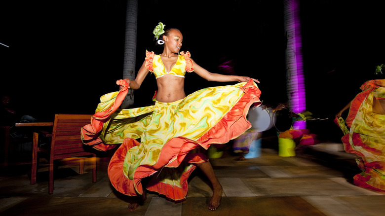 African woman dancing in skirt