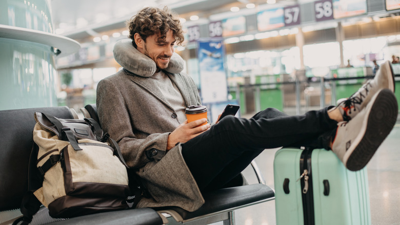 smiling man sitting in airport