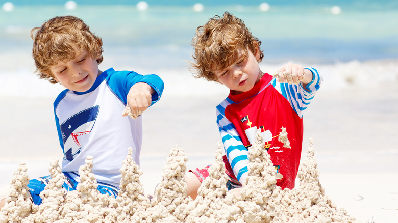 Two boys building sandcastles