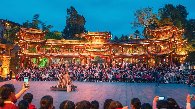 Gold Chinese building and crowds watching performance