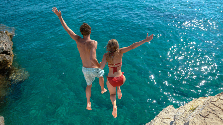 Couple cliff jumping