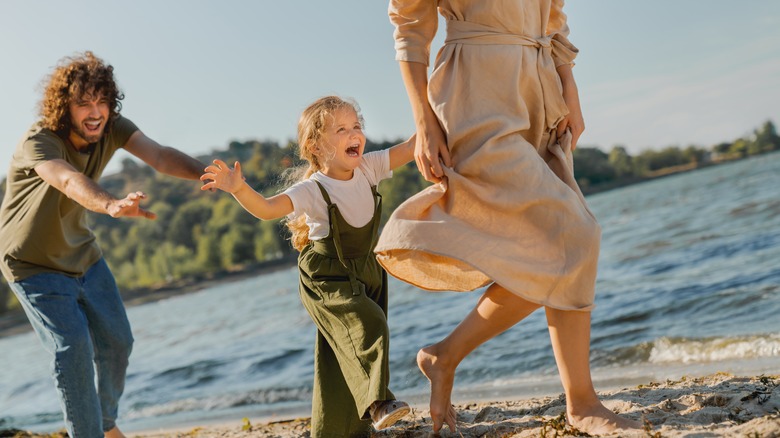 family playing on the beach