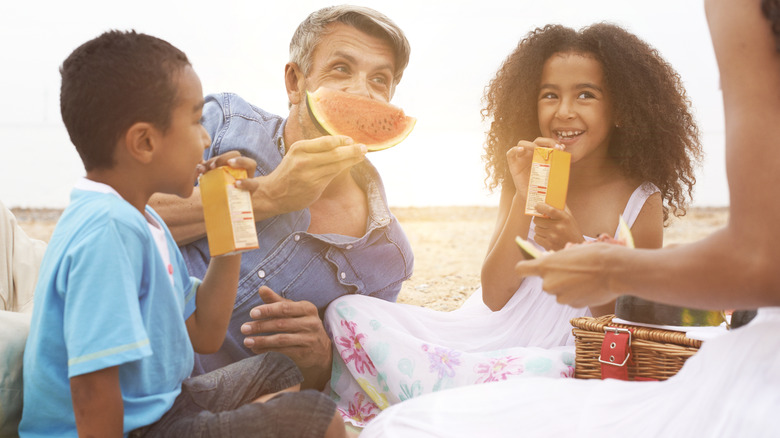 family picnicking on the beach