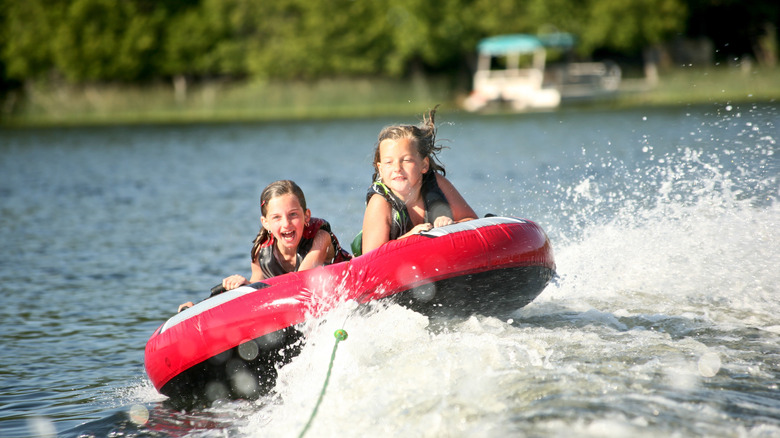 kids tubing on the lake