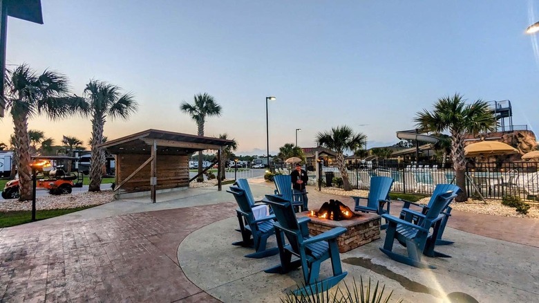 Blue rocking chairs around fire pit at North Myrtle Beach RV Resort