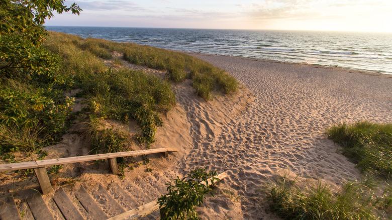 A sandy beach on Lake Michigan at sunset