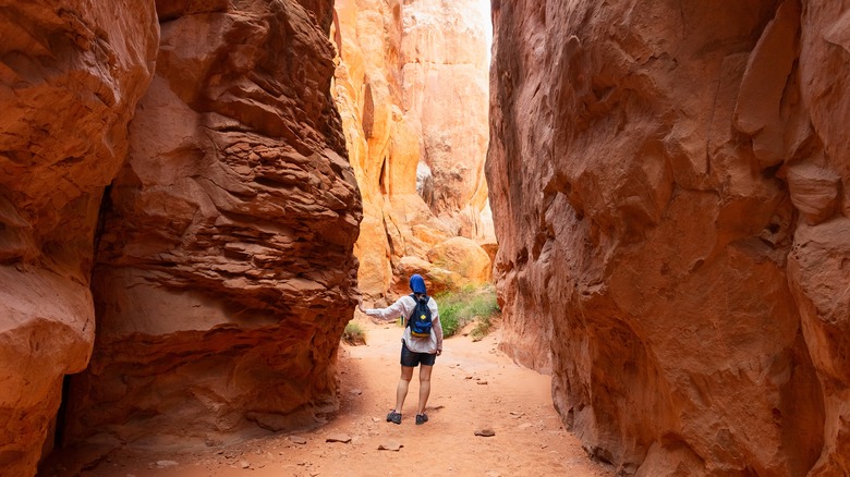 hiker in red slot canyon