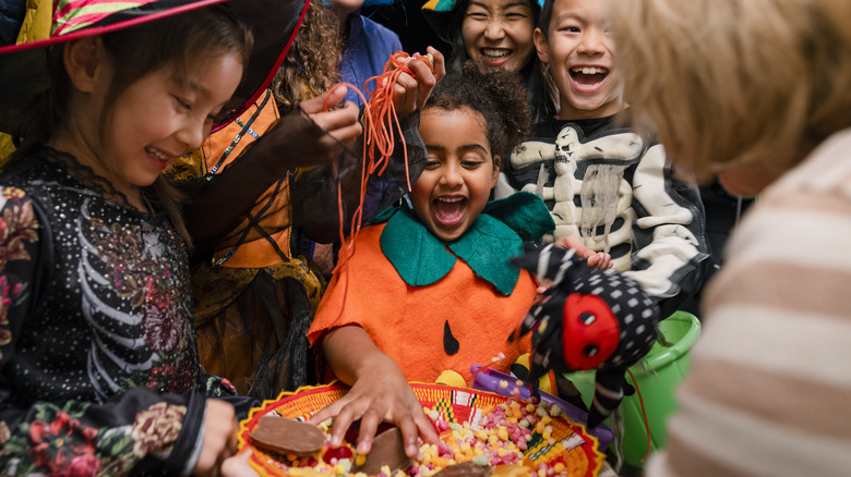 Kids in costume grabbing candy