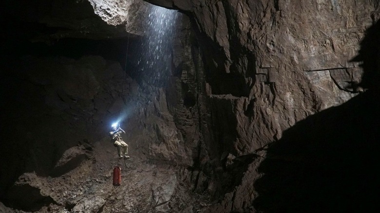 Caver exploring Veryovkina Cave