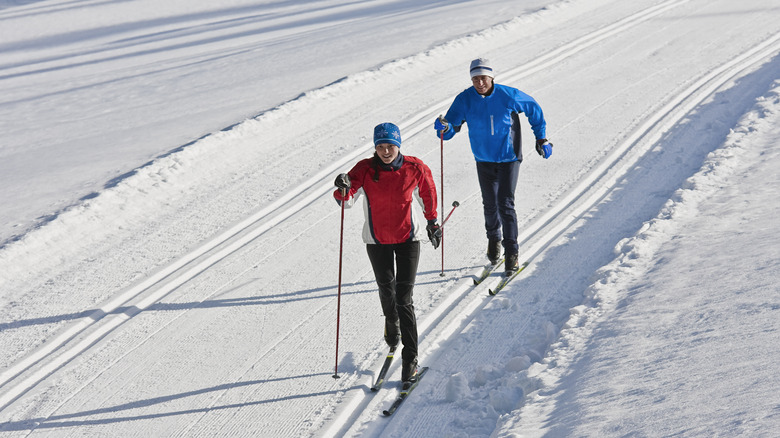 man and woman nordic skiing