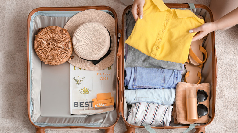 Woman packing a suitcase