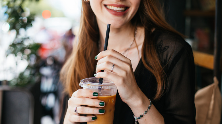 Woman drinking iced coffee