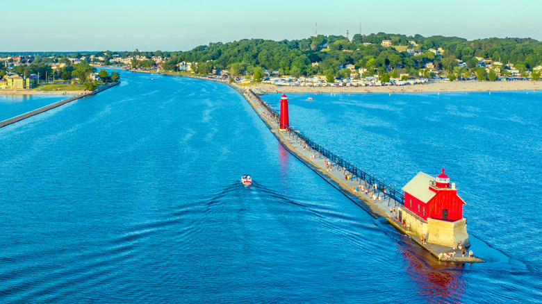 Pier leading to lighthouses surrounded by blue water