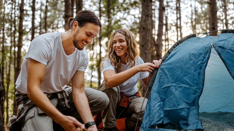 Couple pitching a tent