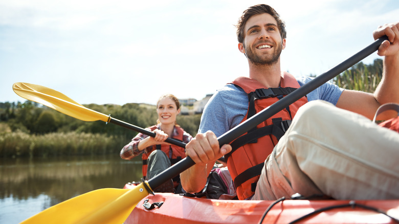 Smiling couple kayaking