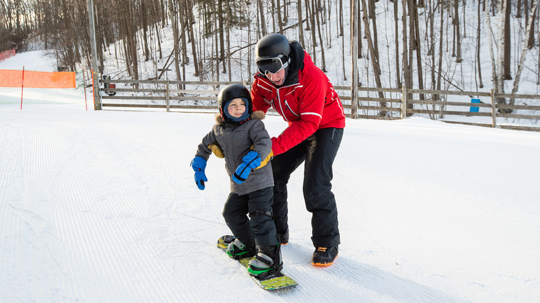 Instructor giving a snowboarding lesson