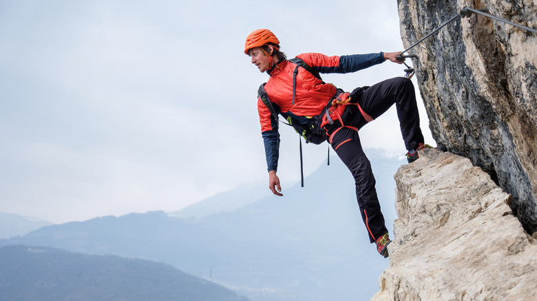 Hiker hanging on ledge