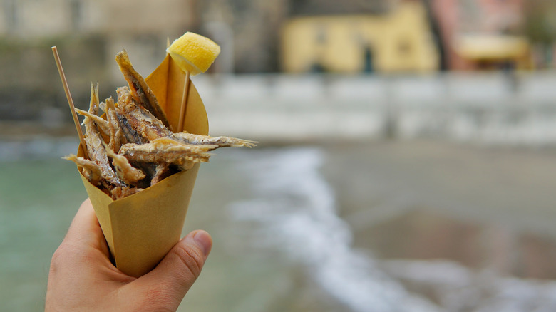 hand holding fried Italian anchovies