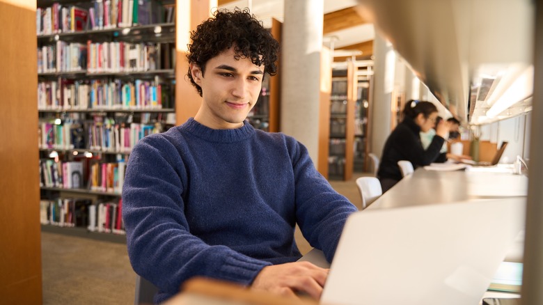 Student using laptop in library