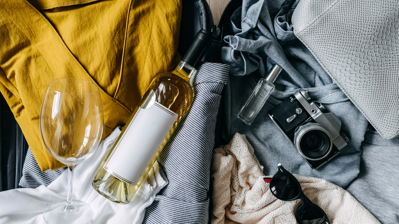 Wine bottle in open suitcase