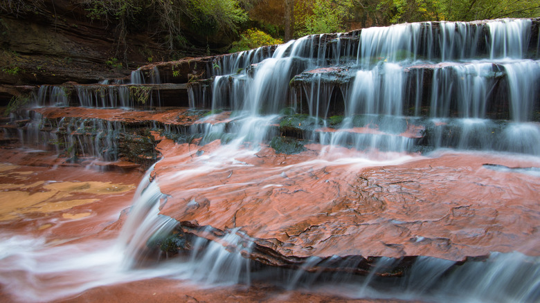 waterfalls cascading down red rocks
