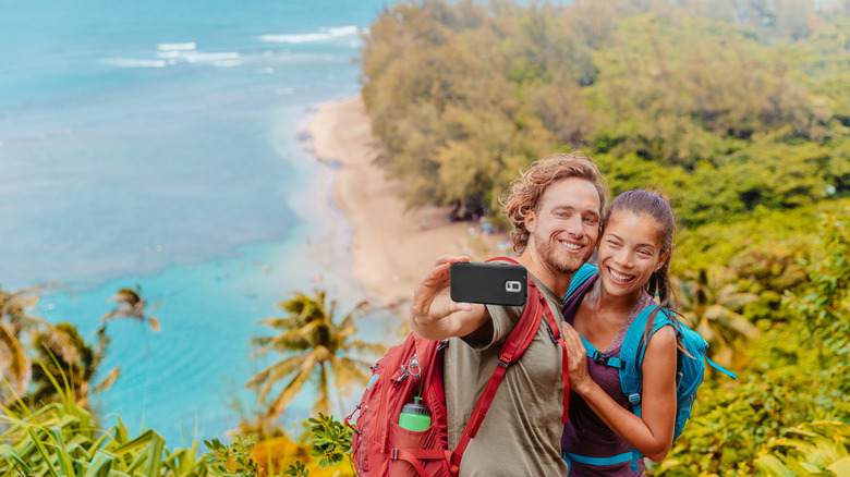 couple taking selfie on island