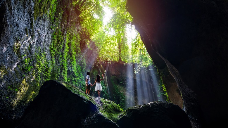 Couple standing on mossy rock