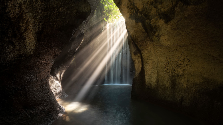 Rays of light illuminating waterfall