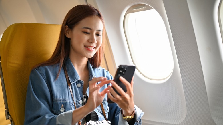 Woman in window seat on airplane