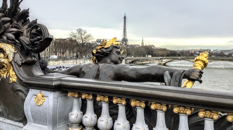 Statue with Eiffel Tower in distance