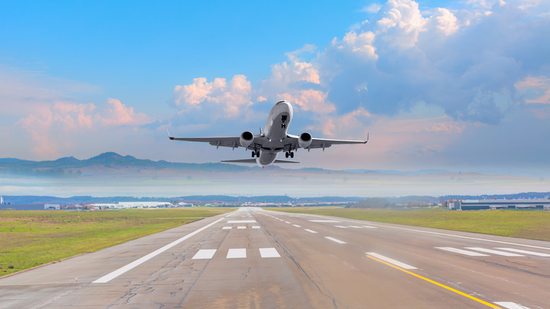 Plane taking off over runway