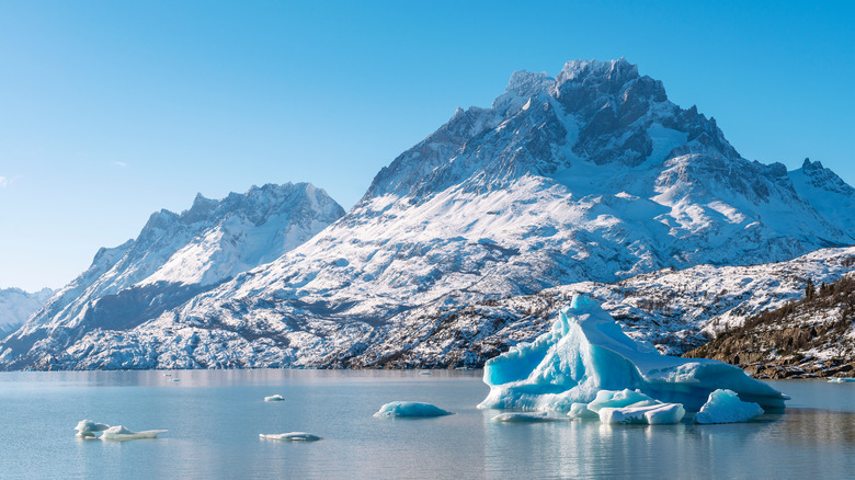 blue iceberg on grey lake