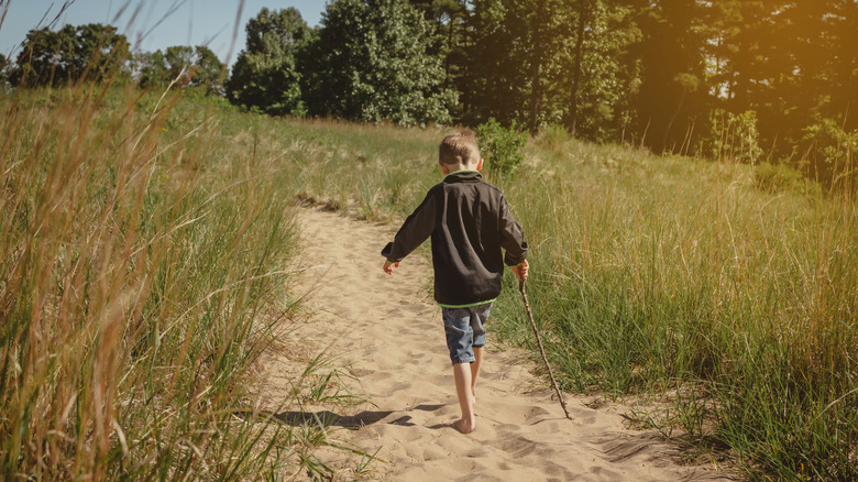 Young boy on sandy trail