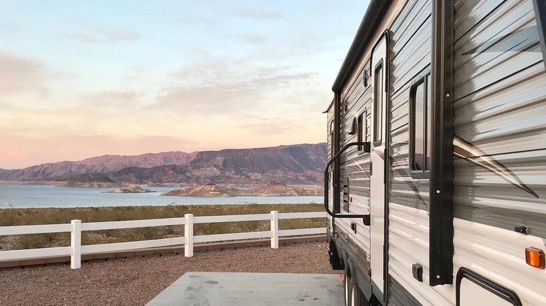 RV parked with lake and mountain view