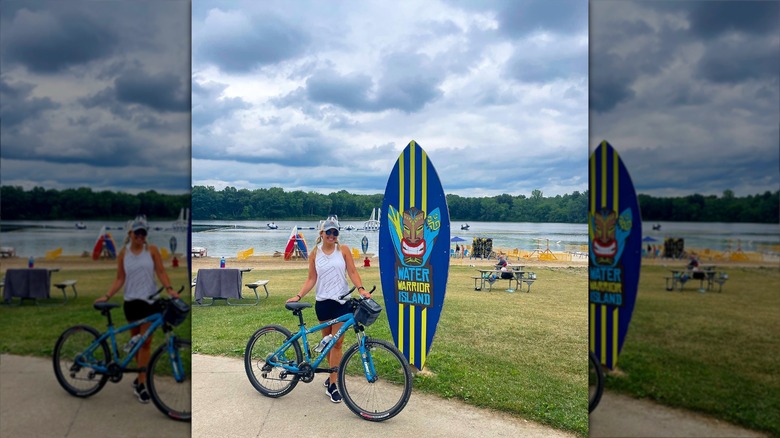 Woman by bike and lake