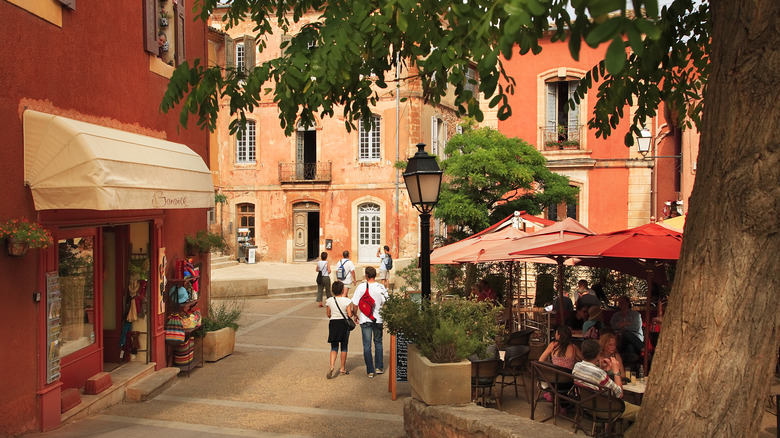 ocher buildings with cafes and store