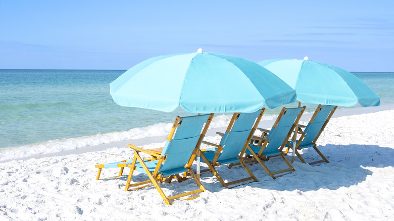 Deckchairs on white sand beach
