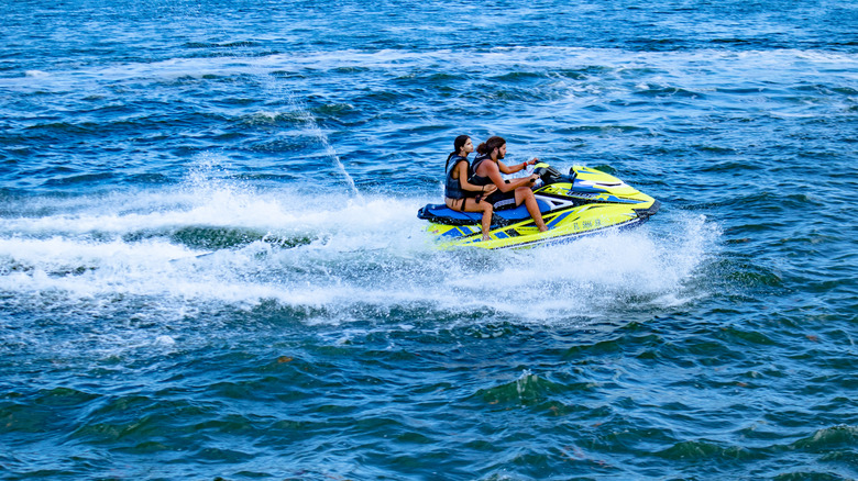 Couple riding a jet ski