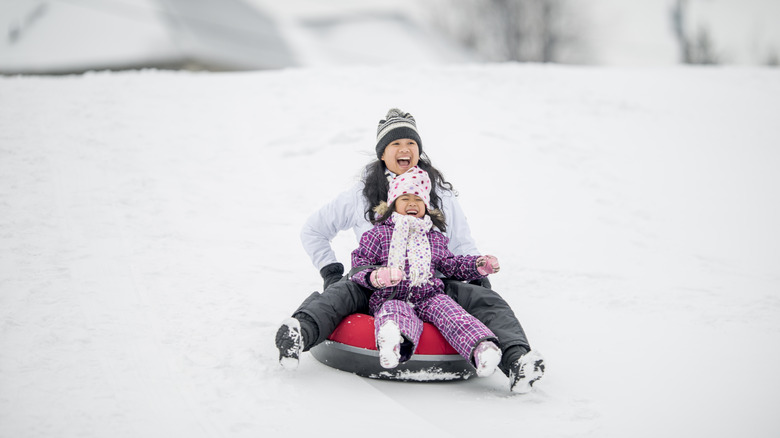 Woman and child tubing on snow