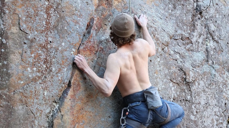 person climbing rocks at Johnson's Shut-Ins