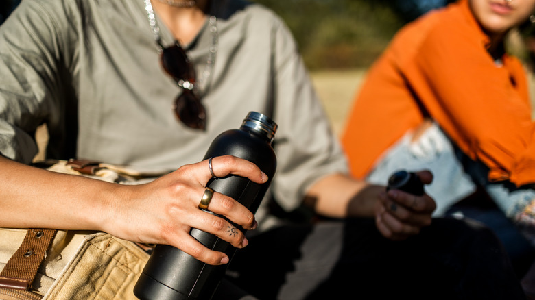 Hiker holding water bottle