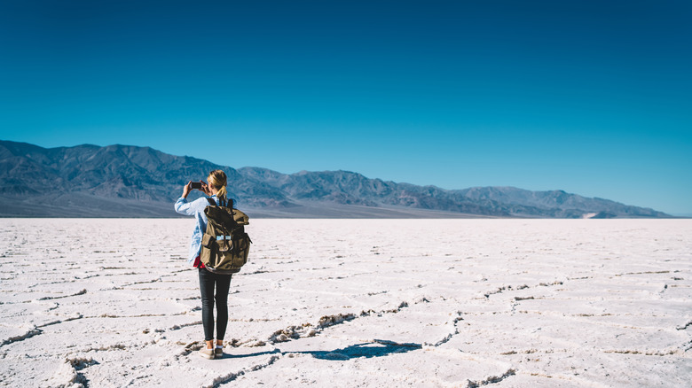 person taking photo at Badwater Basin