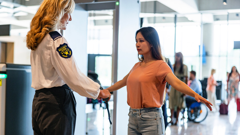 airport security officer and woman